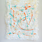 Witte foamie met verfspatten